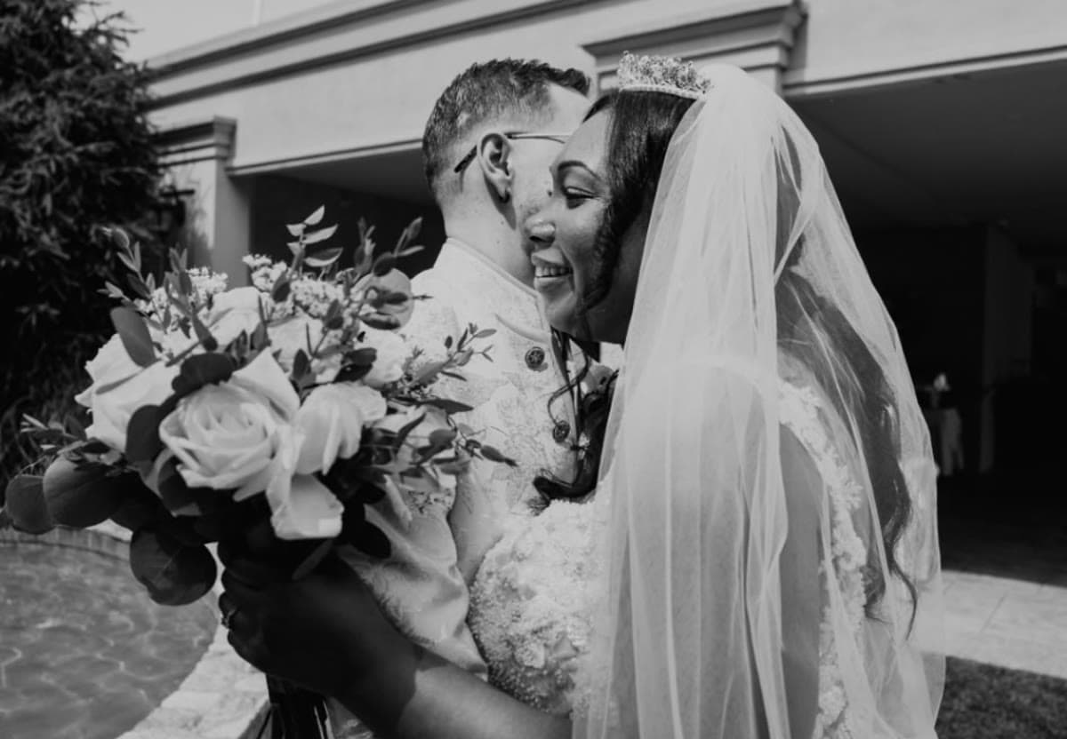 A couple, their wedding rings, and a cross — a moment at Dunbar